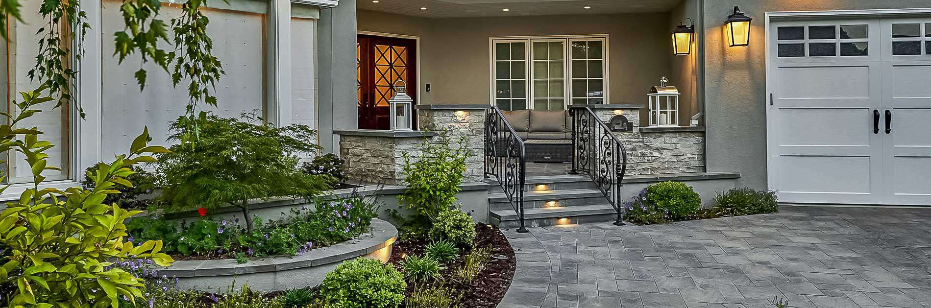 Front entryway with flagstone driveway and landscaped garden feature